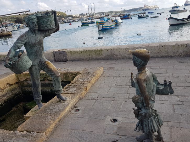 Marsaxlokk Bay (with statue of Peter , Malta - where Europe meets the Caribbean the fisherman)
