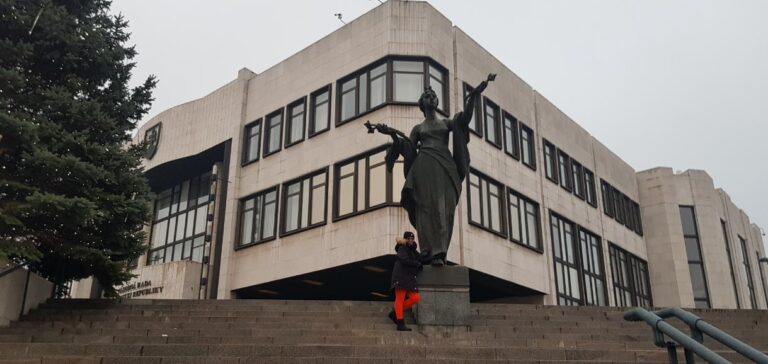 Slovakia, a Beauty in the Heart of Europe. CoraDexplorer and the Welcoming Statue in front the Slovak Parliament National Council