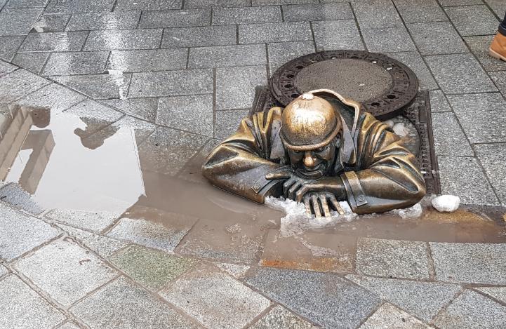 Slovakia, a Beauty in the Heart of Europe. Statue (depicts a man climbing out of the sewer)