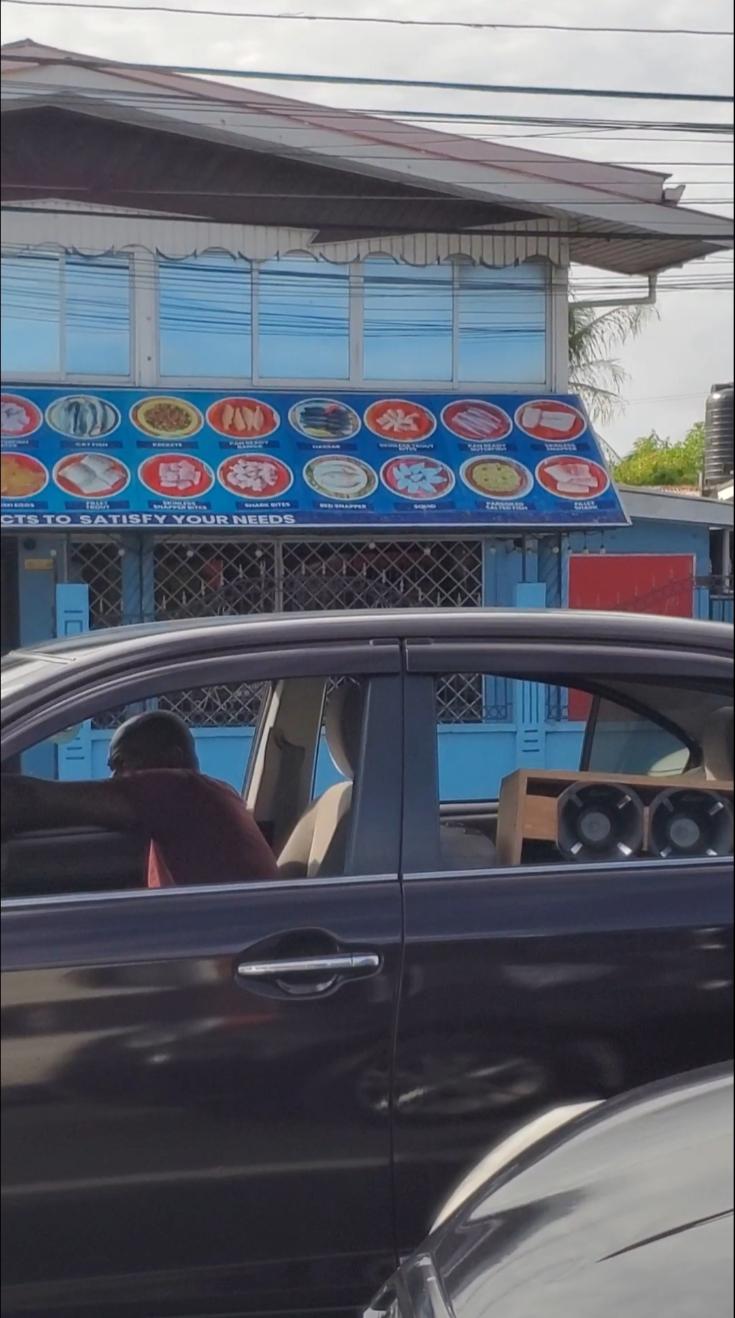 Driver with loud music speakers facing out of his vehicle. Guyana, the Land of Many Waters