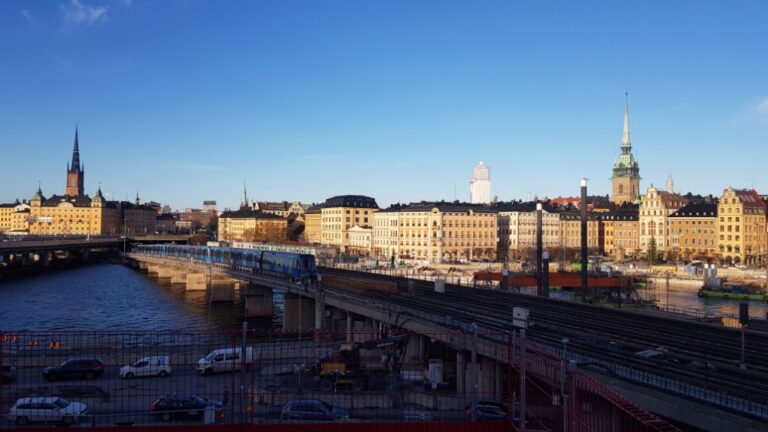 Stockholm City Hall and train crossing over the lake. Sweden is a cold and cashless society.
