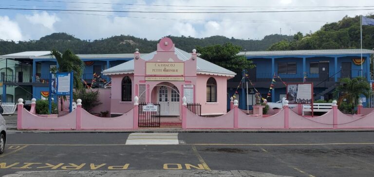 The Carriacou & Petite Martinique Tourism Authority - Carriacou and the police station behind (blue). Grenada, the Spice Isle of the Caribbean