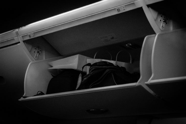 overhead luggage bin with duty-free or personal item. top 15 most annoying airplane experiences