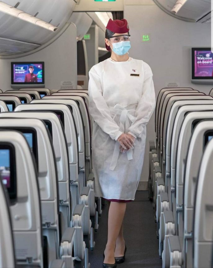 qatar airway cabin staff wearing PPE on-board. planning to travel during COVID-19.